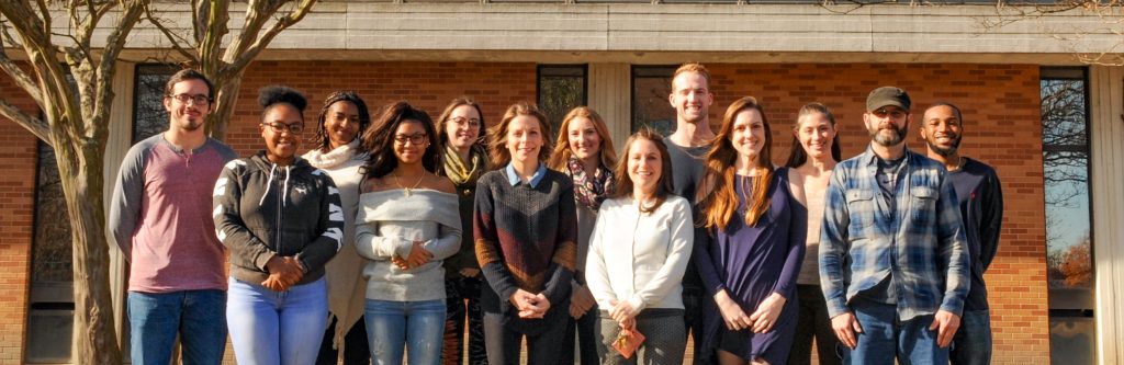 Graduate and undergraduate research assistants with Dr. Braitman, standing outside of the Psychology building on ODU's campus.