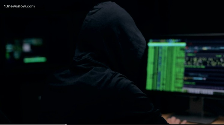 Suspicious person looking at computer screens 