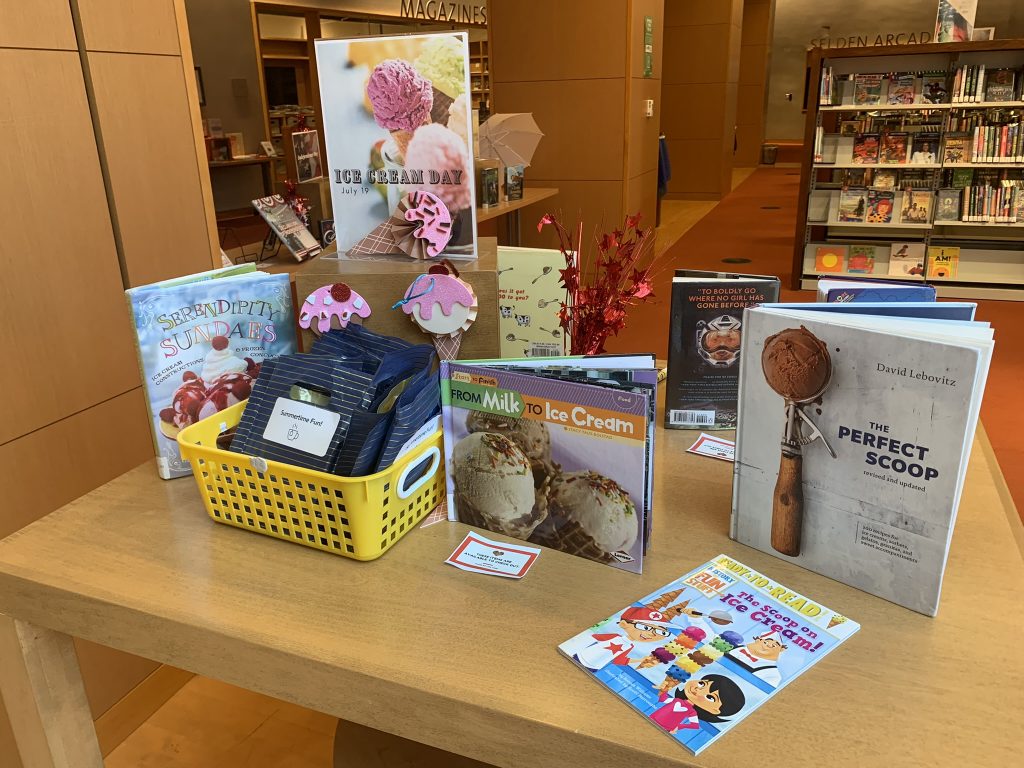 A table featuring books and media about ice cream.