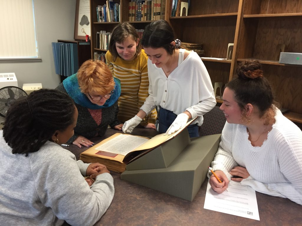 Students looking at rare book