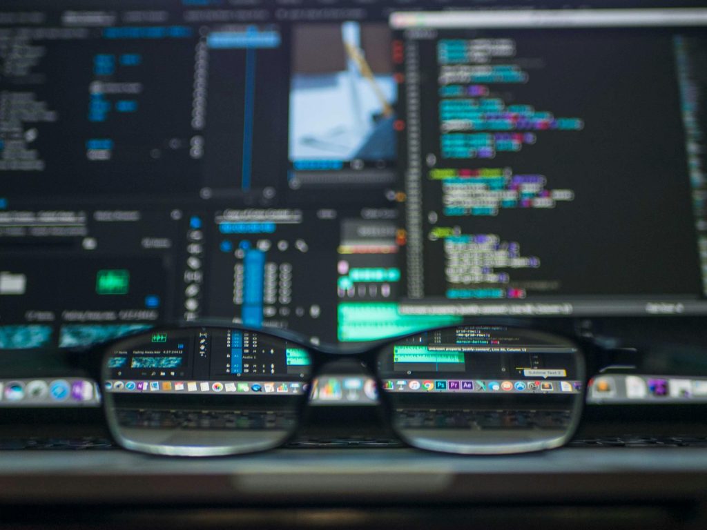 Computer screen with glasses in focus.Photo by Kevin Ku: https://www.pexels.com/photo/data-codes-through-eyeglasses-577585/
