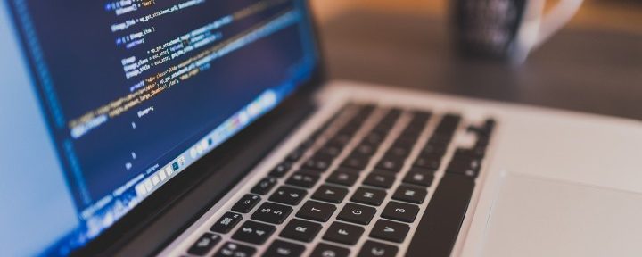 Open Laptop with code displayed across the screen